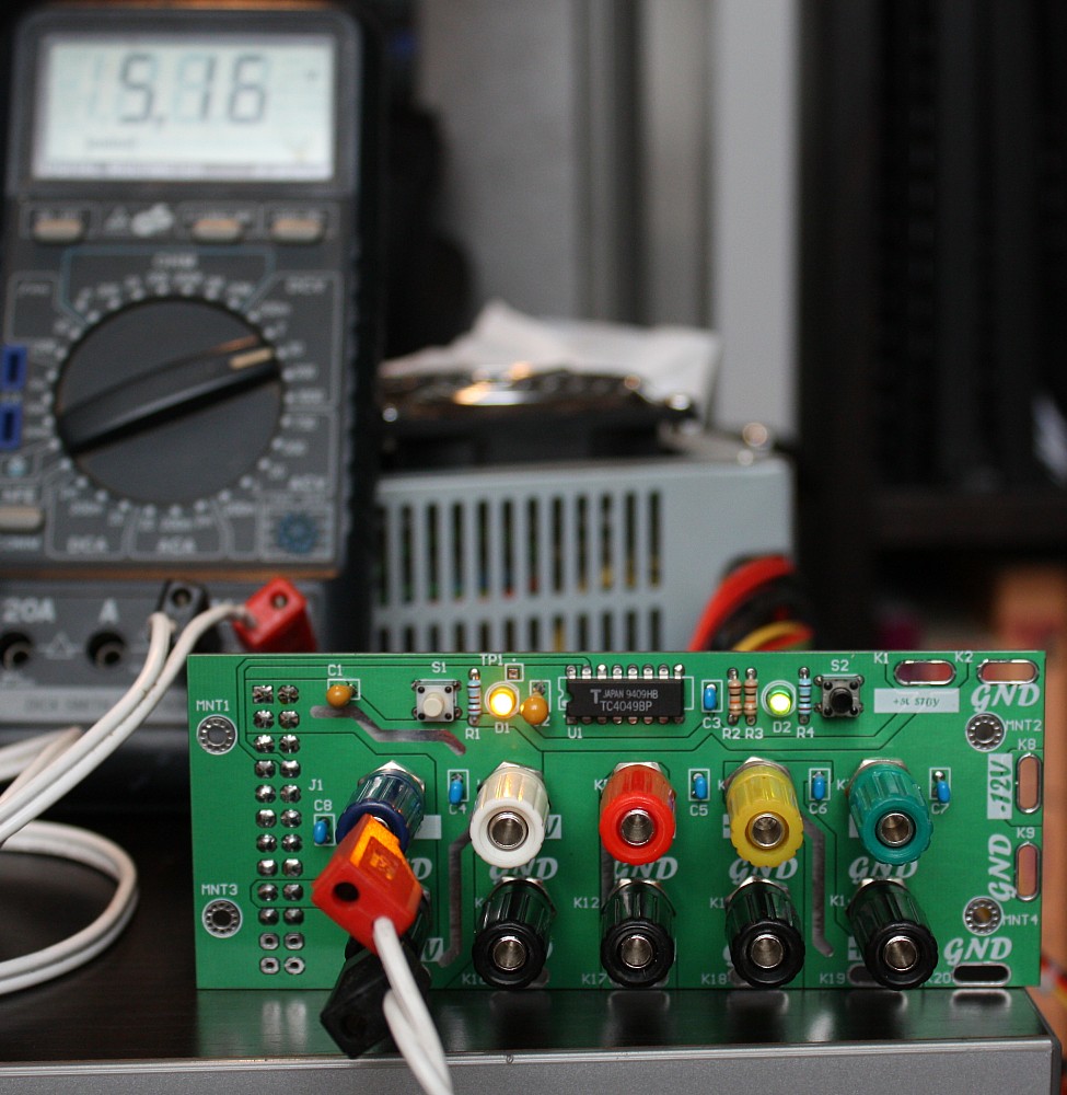 Front view of prototype adapter. Front view of adapter board with DMM leads connected